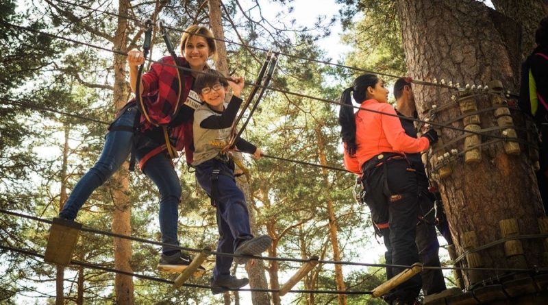 A family enjoys a thrilling day on a ropes course in Cercedilla, Spain.